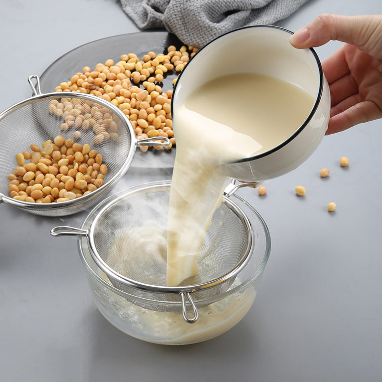 Large stainless steel strainer with wooden handle and double ears, suitable for home use as a frying ladle or noodle strainer